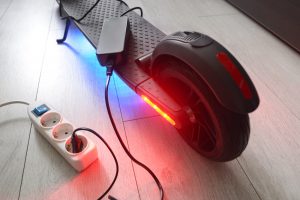 Battery,Charging,Process,Of,Gray,Electric,Stand-up,Scooter.
